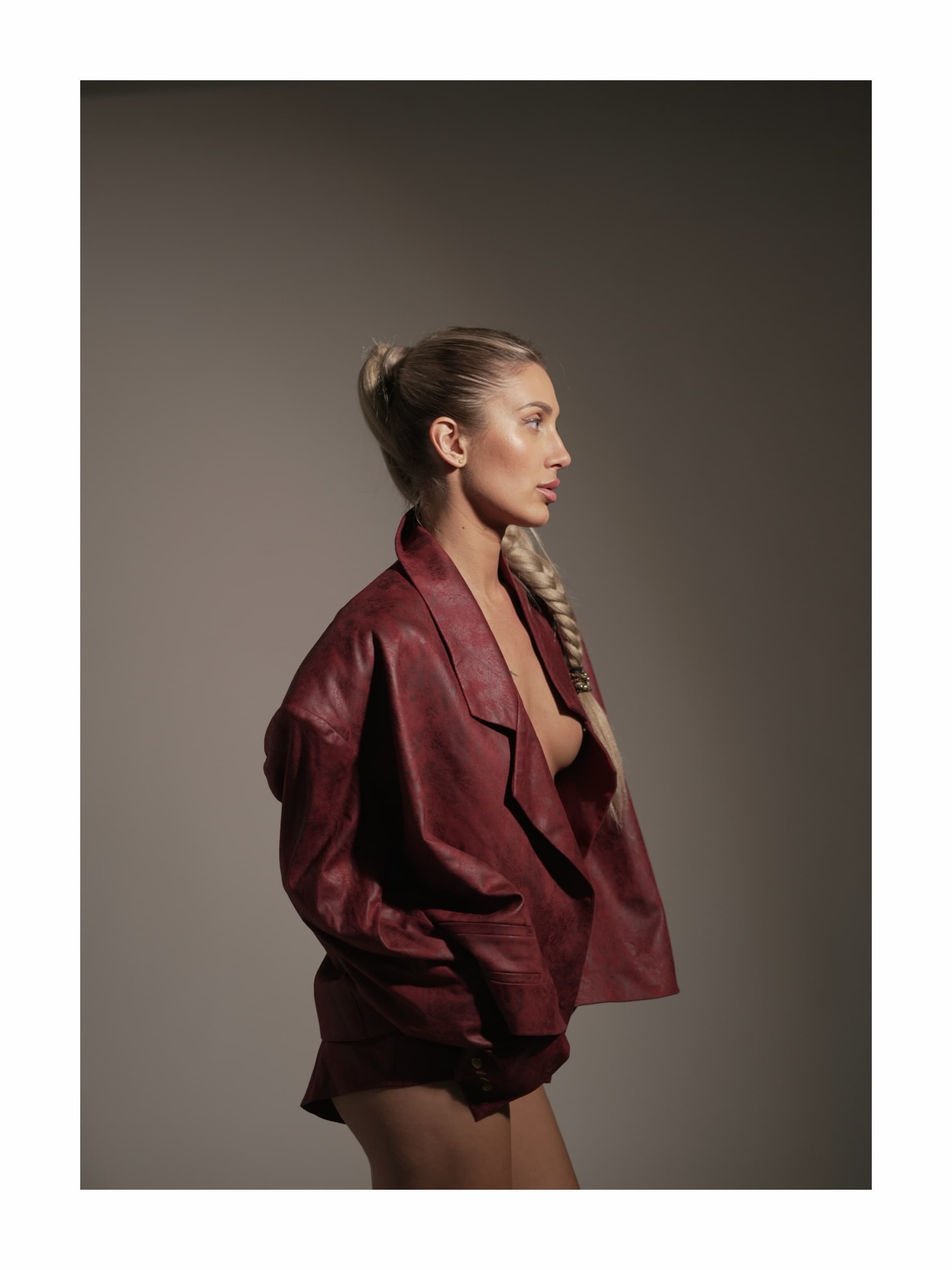 Profile portrait of Lisa Manila in a burgundy Lyssai Limited look