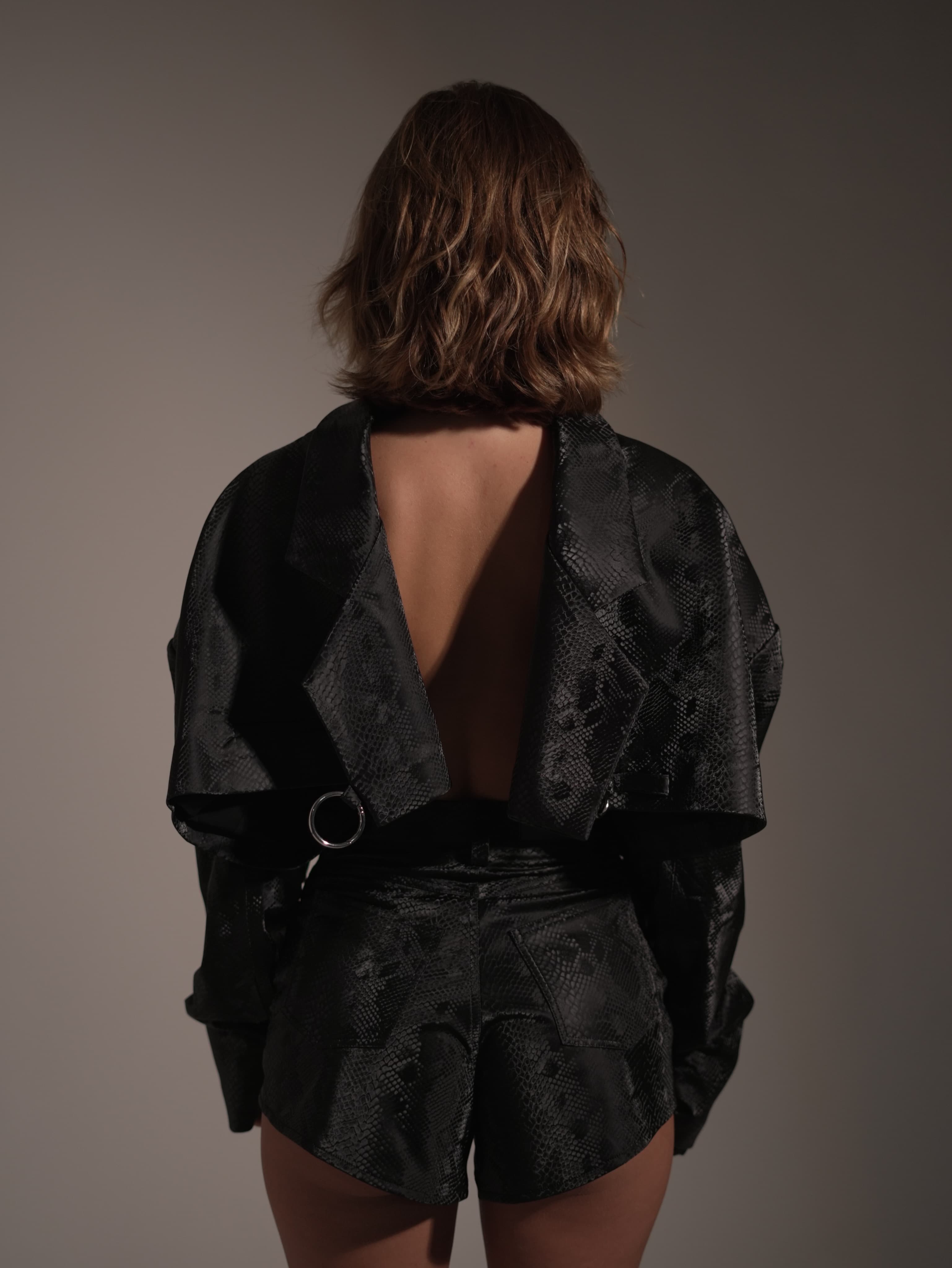 Back view of Masha in a sculptural black fashion look