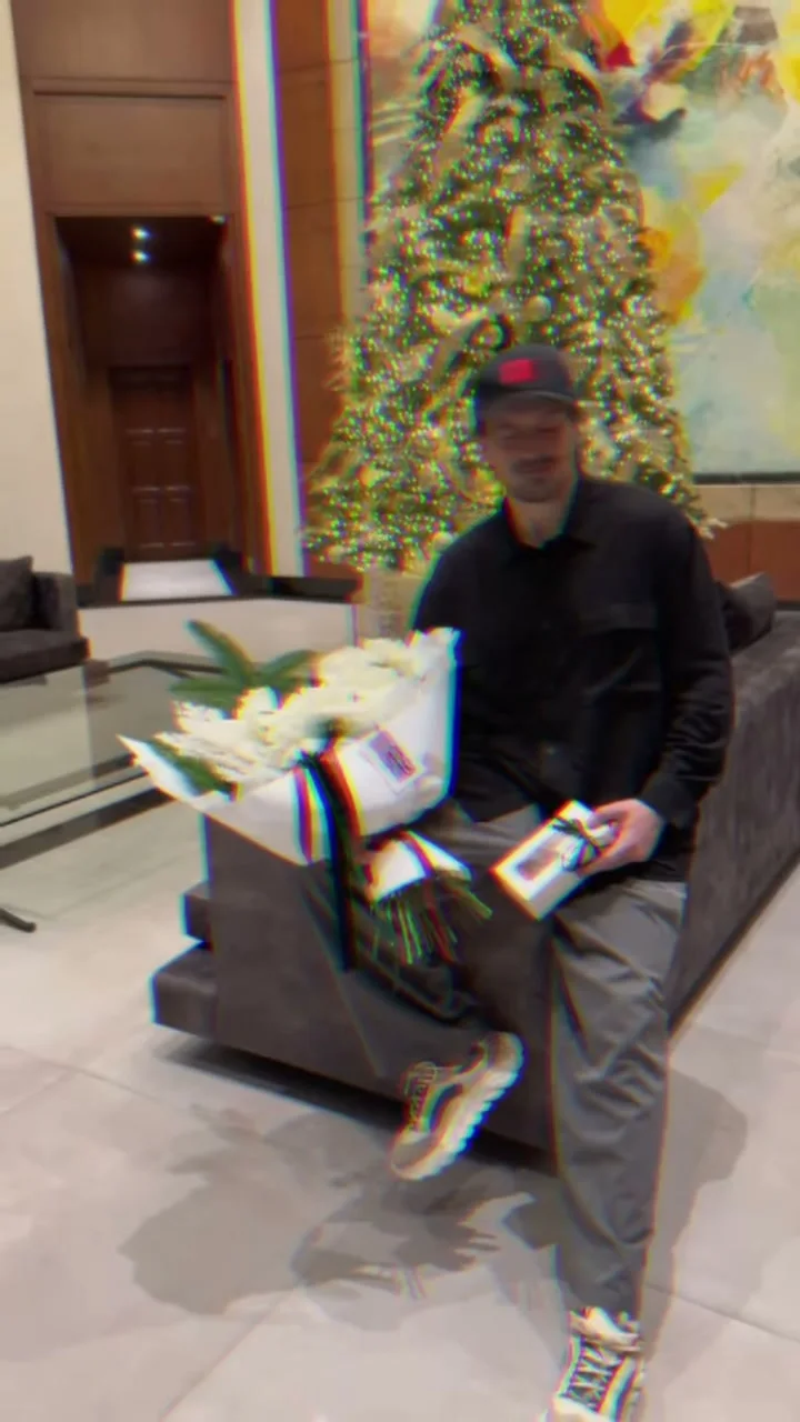 Man seated in a Manila lobby with Holy Chic gift packages