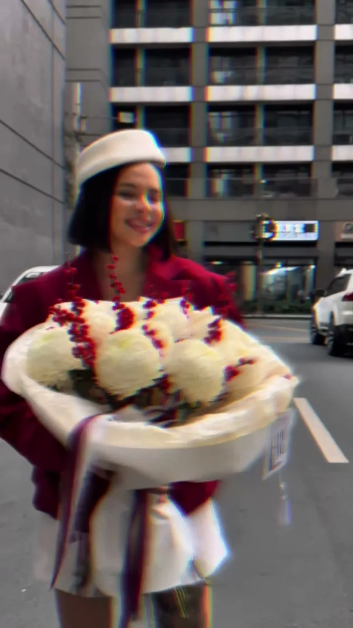 Woman carrying an oversized white and red rose bouquet in BGC