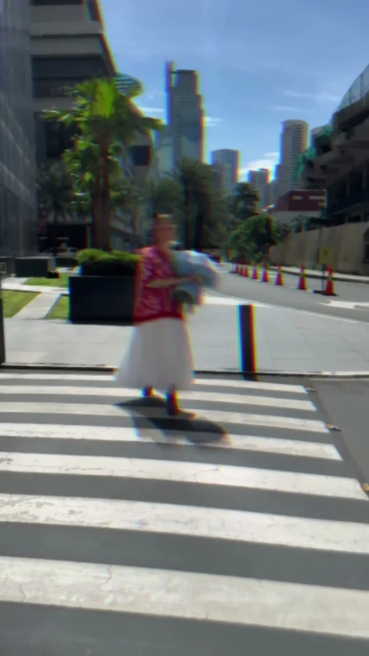 Woman carrying a Holy Chic bouquet across a street in BGC