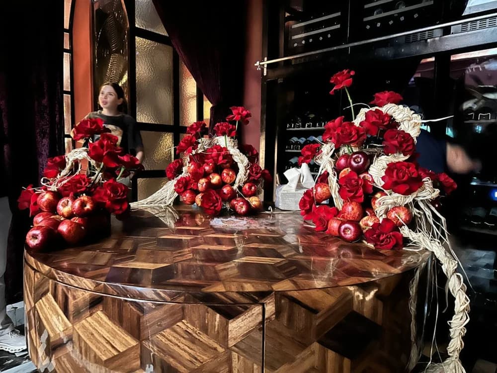 Backstage view of Holy Chic arranging red roses and fresh apples at Medusa BGC
