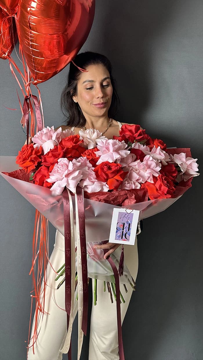 Holy Chic customer holding a pink and red anniversary bouquet