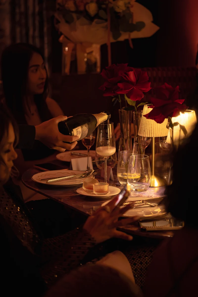 Red rose dinner table styling at Medusa BGC Guests dining at a table styled with red roses at Medusa BGC