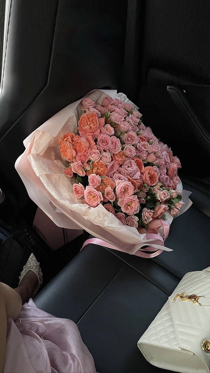 Bright bouquet of spray roses in round wrapping