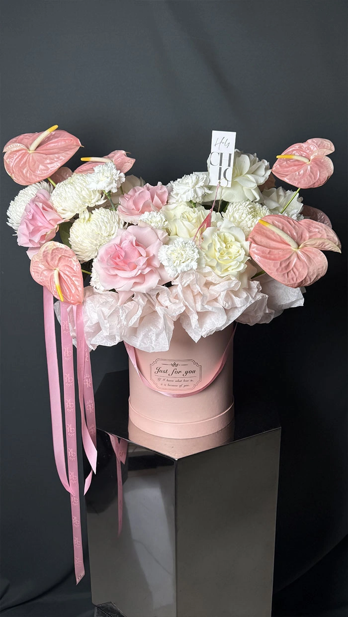 A flower box in pink and white tones with different textures